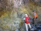 Geologists examining outcropping silica-pyrite-pyrophyllite mineralization in Escandelosa